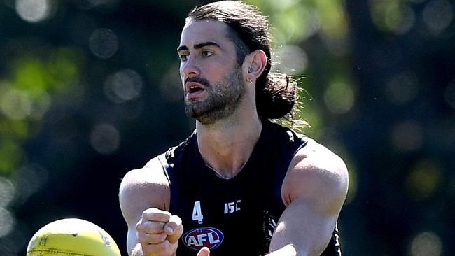 SUNSHINE COAST, AUSTRALIA - AUGUST 05: Brodie Grundy gets a handball away during a Collingwood Magpies AFL training session at Maroochydore Multi Sports Complex on August 05, 2020 in Sunshine Coast, Australia. (Photo by Bradley Kanaris/Getty Images)