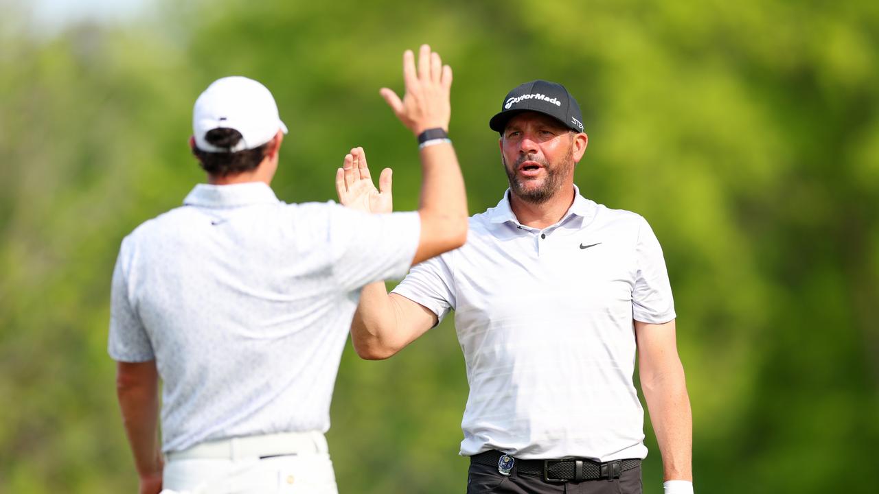 Michael Block (R) of the United States, celebrates the ace with Rory McIlroy.