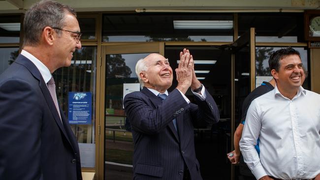 Former prime minister John Howard with South Australian Premier Steven Marshall (left) and local MP Richard Harvey during a visit to Modbury Bowling Club. Picture: AAP Image