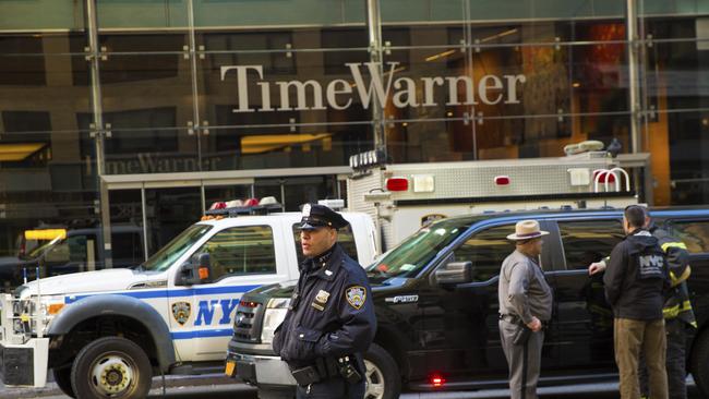 An officer keeps watch in front of the Time Warner building after one of the devices was found. Picture: AP.