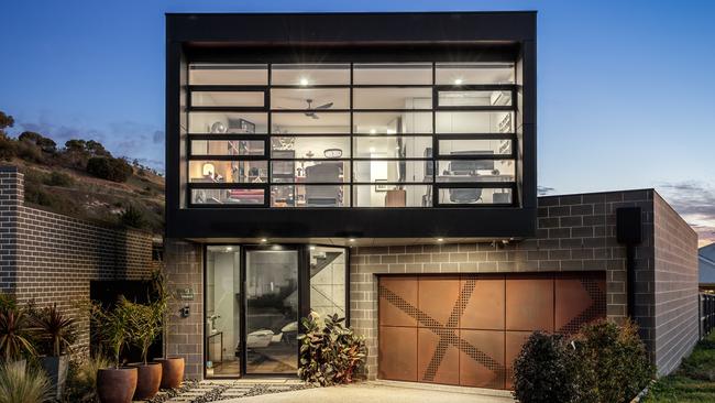 The corten garage door and motorbike in the entry are a sign 9 Maskell Court, Fyansford, does things differently.