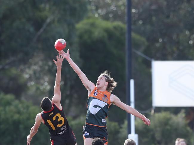 Geelong West's Tylar Watts (67) gets a tip above St Joseph's Paddy De Grandi (13). GFL: St Joseph's v Geelong West. Picture: Alan Barber