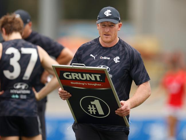 Michael Voss holds the coach's board during an AFL practice match between the Carlton Blues and the St Kilda Saints. Picture: Michael Willson/AFL Photos via Getty Images