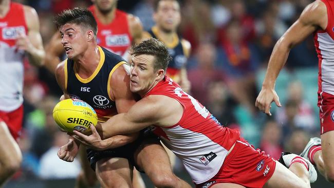 Riley Knight is tackled by Sydney’s Luke Parker. Picture: Phil Hillyard