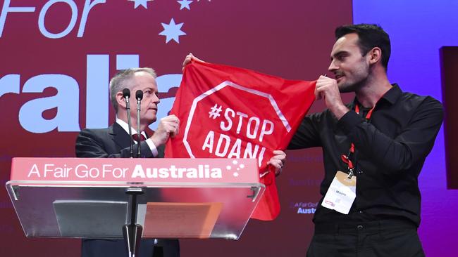 Bill Shorten takes the flag from Isaac Astill. Picture: AAP / Lukas Coch