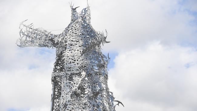 The final stage of the installation of Corey Thomas' 12 metre tall lighthouse sculpture on the new Bayshore Drive Roundabout at Byron Bay. PHOTO: Marc Stapelberg