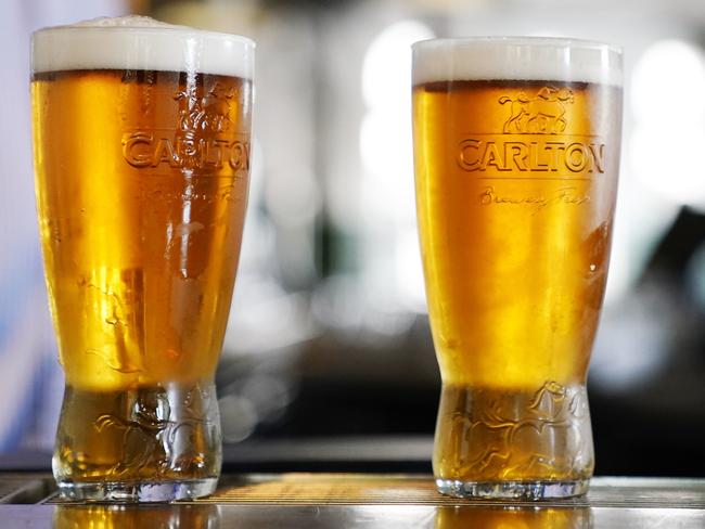 Two pints of beer are seen at the bar during the 'For the Love of Your Local' Buy a beer for later campaign launch at the Village Belle Hotel in Melbourne, Monday, April 6, 2020. Carlton & United Breweries and the Australian Hotels Association have teamed up to call on Australians to buy a pint now to drink later. (AAP Image/Scott Barbour) NO ARCHIVING