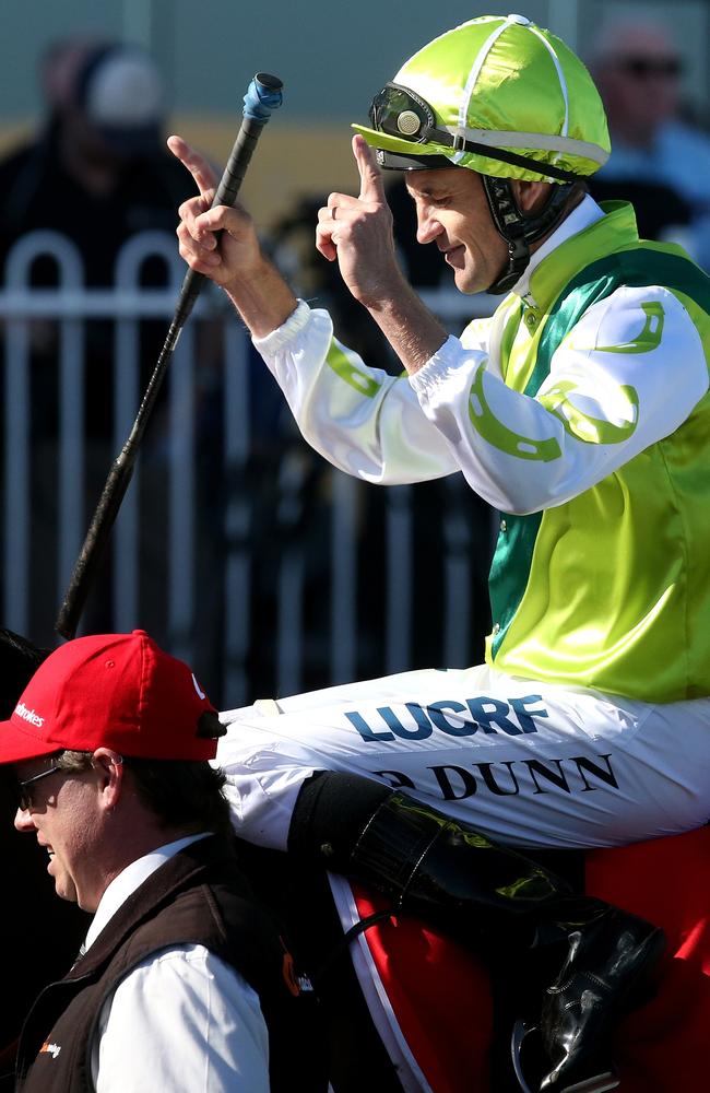 Jockey Dwayne Dunn salutes as he returns to scale. Picture: Mark Dadswell