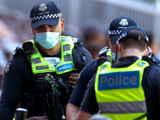 MELBOURNE, AUSTRALIA - DECEMBER 26: Police speak to crowd due to behaviour during day one of the Second Test match between Australia and India at Melbourne Cricket Ground on December 26, 2020 in Melbourne, Australia. (Photo by Kelly Defina/Getty Images)