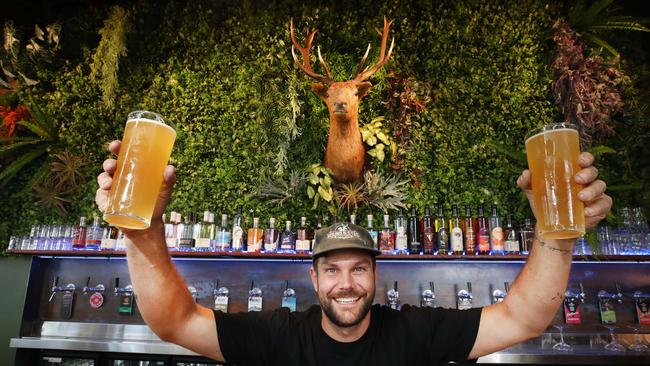 Hound and Stag owner Cuan Roberts behind the bar with beers and Frank the Stag. Picture: Glenn Hampson