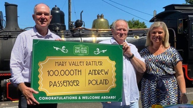 Gympie MP Tony Perrett, the rattler's 100,000th passenger Andrew Poland and Rattler general manager Linda Barry.