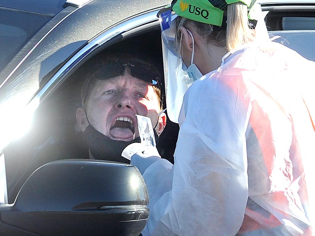 A man has a COVID test done in Orion Springfield Central Shopping Centre. Picture: NewsWire / John Gass