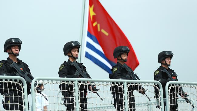 Members of the Chinese Navy stand on the deck of a navy ship in Zhoushan, Zhejiang Province. Picture: Getty Images