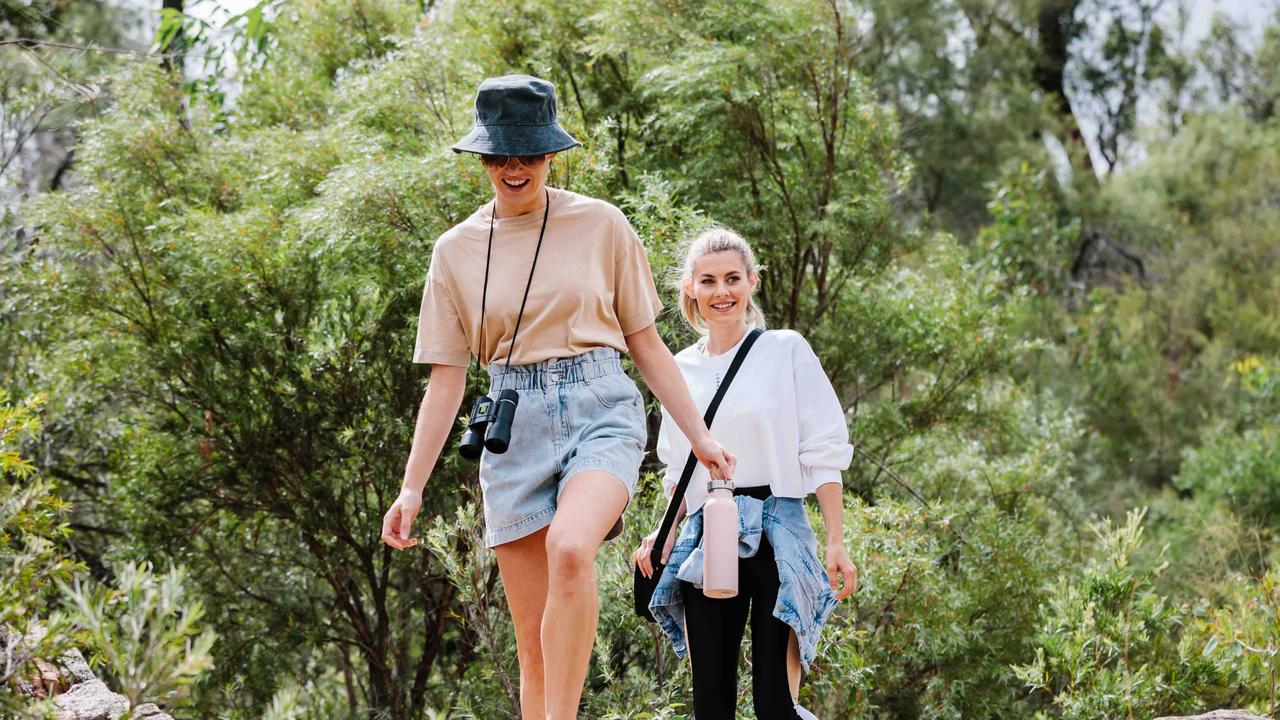 Autumn fashion trends from Grand Central. Meghan McVeigh (outfit is from Seed, binoculars from Kathmandu) and Kaitlin Lee (outfit is from Lorna Jane, denim jacket from Target).