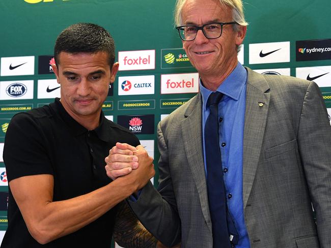 Tim Cahill shakes hands with FFA boss David Gallop after the press conference on Tuesday.