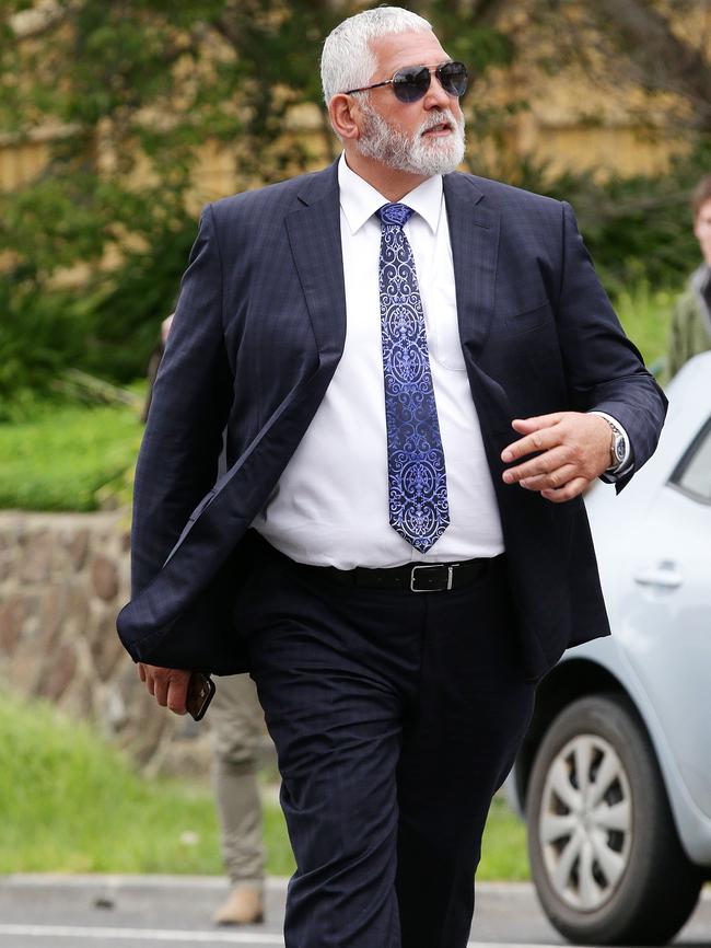 Gatto striding from court in his silver and navy tie. Picture Norm Oorloff