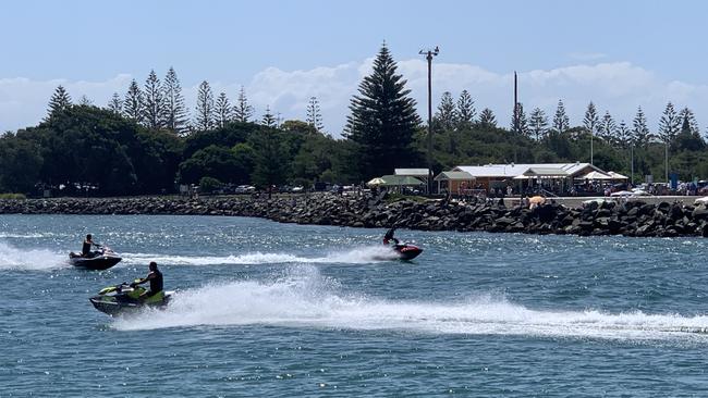 Jet skis out in force on Wallis Lake between the Forster and Tuncurry breakwalls. Picture: Janine Watson.