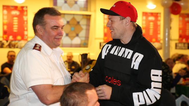 De Goey shakes hands with Salvation Army Major Brendan Nottle at a Salvos footy finals lunch. Picture: Michael Klein