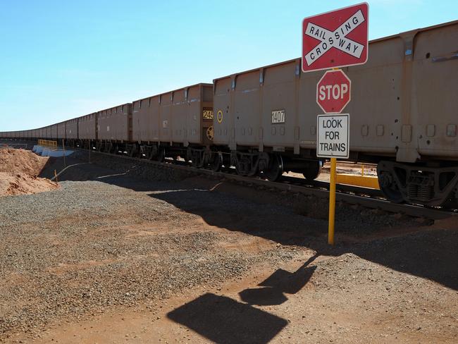 A Fortescue Metals Group train loaded with iron ore, arrives in Port Hedland from the Cloudbreak mining operation in Cloudbreak in Western Australia, on Monday, Jul. 25, 2011. Photographer: Carla Gottgens/Bloomberg