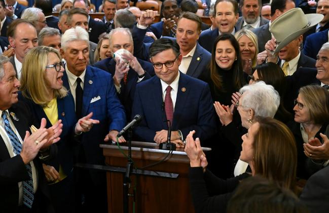 Mike Johnson (C) had faced unrest from fellow Republicans as he aimed to retain his role as US House Speaker