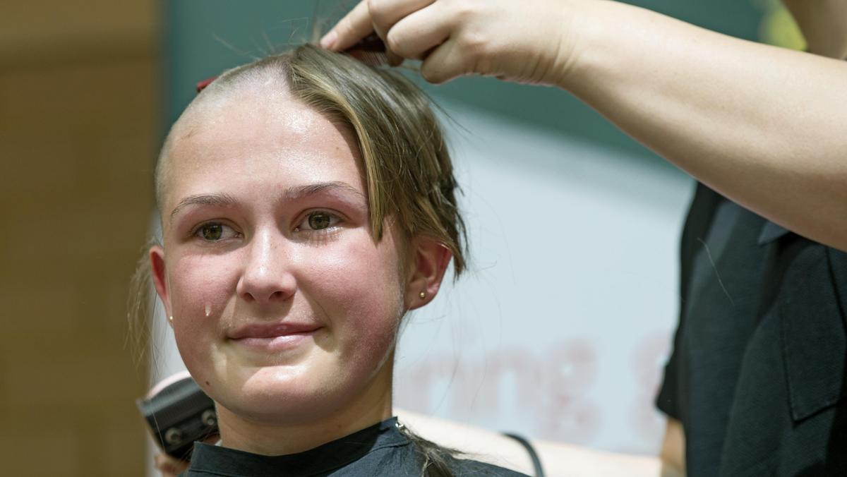 Penrhos College student Zoe Dick sheds a tear as her locks come off.