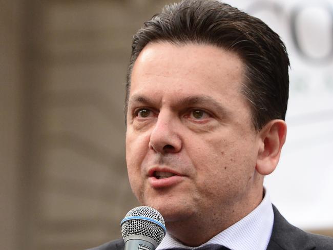 South Australian Independent Senator Nick Xenophon speaks as dairy farmers rally outside Parliament House following a march in Melbourne, Wednesday, May 25, 2016. Victorian dairy farmers, stock horses and a cow have paraded through Melbourne's streets in protest against the low milk prices, as the federal government announced struggling dairy farmers will be able to access a $578 million support package. (AAP Image/Mal Fairclough) NO ARCHIVING