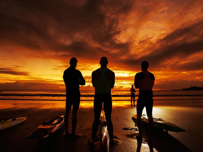 Mooloolaba Surf Club board riders make the most of the winter solstice by hitting the water at sunrise. Picture Lachie Millard
