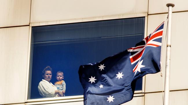 A woman and her child look out a window at the Park Royal Hotel at Melbourne Airport where CQV is investigating a potential transmission of coronavirus between hotel quarantine residents. Picture: David Geraghty