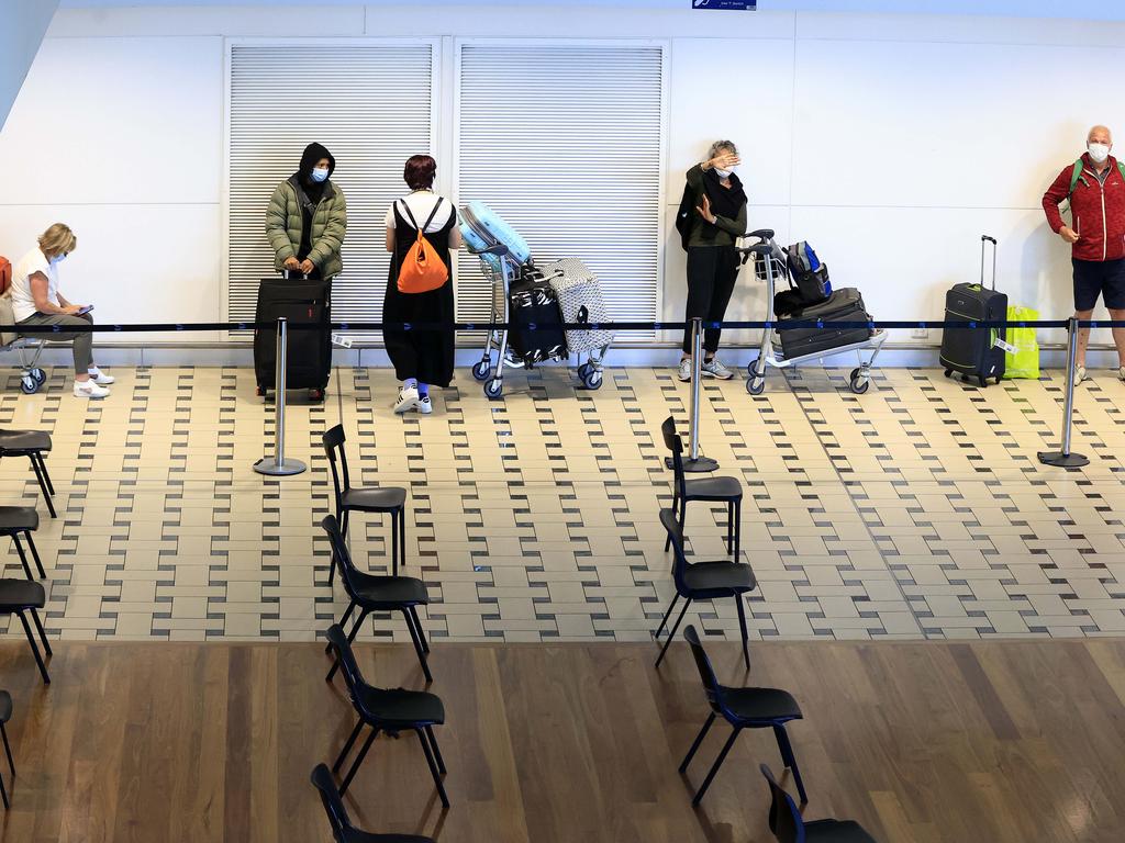 People waiting in a hotel quarantine line after arriving at Brisbane International Airport on flights from Singapore and New Zealand. Picture: Adam Head