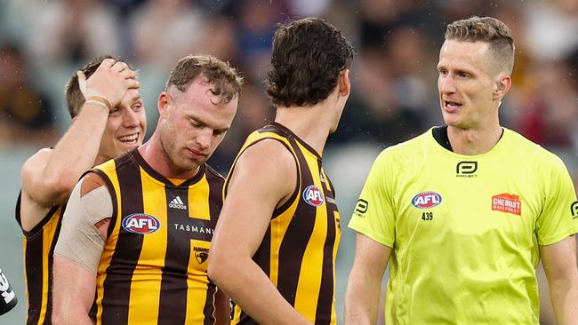 Tom Mitchell talks to field umpire Hayden Gavine after a controversial 50m penalty was awarded. Picture: AFL Photos via Getty Images