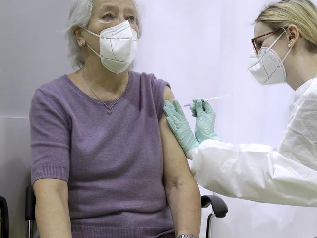 BERLIN, GERMANY - FEBRUARY 17: Renate Schulz, left, receives a 'Moderna COVID-19' vaccination by doctor Laura Tosberg, right, at a new coronavirus, COVID-19, vaccination center at the 'Velodrom' (velodrome-stadium) on February 17, 2021 in Berlin, Germany. (Photo by Michael Sohn - Pool/Getty Images)