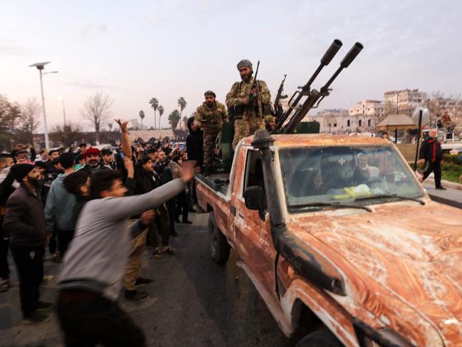 Residents take to the streets of Hama, to welcome anti government fighters. Picture: AFP