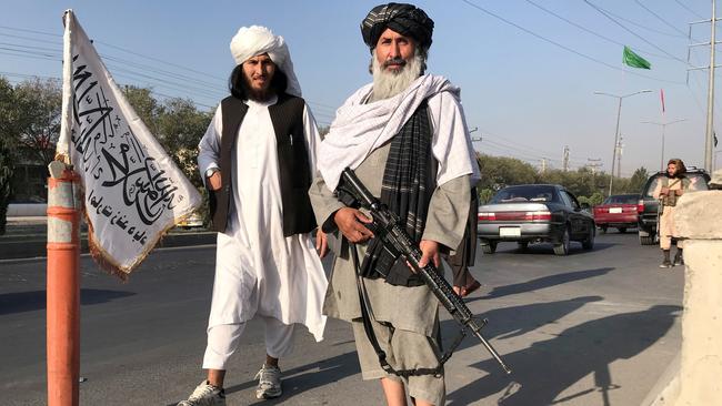 A Taliban fighter holding an M16 assault rifle stands outside the Interior Ministry in Kabul. Picture: Reuters