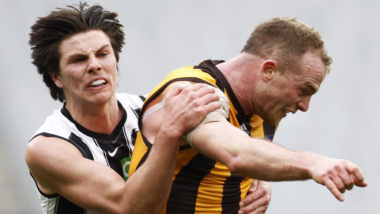 Tom Mitchell of the Hawks is tackled by Oliver Henry of the Magpies. Picture: Daniel Pockett