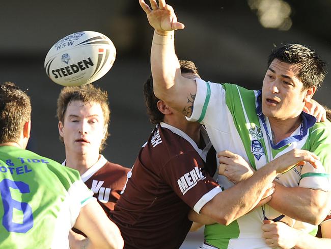 Cromer's Reuben Enoka (right) gets the ball away in an A-Grade Preliminary final against Valley United at Brookvale Oval. Picture: Martin Lange