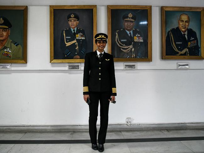 Anny Divya, 31, an Indian pilot who became the youngest woman in the world to captain the Boeing 777 aircraft, next to portraits of various air marshals at the Indian Air Force Museum in New Delhi on February 24, 2018. Picture: AFP