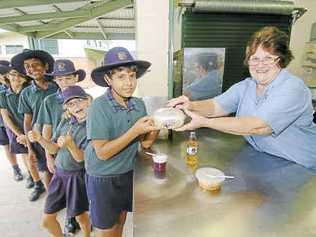 Lining up for some healthy food are (from left) Uvin Seneviratne, Charlie Cummings, Joel Pearson, Amjad Aslam, Ella Cummings, Emily Shiels and Shayne Tobias, greeted by tuckshop convenor Merle Finnis. Picture: Mike Knott