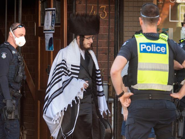 Police fine members of a Jewish Synagogue that have broken the Social distancing rule in Glen Eira road, Ripponlea. Picture: Tony Gough