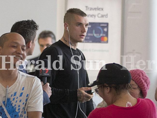 Martin kept his headphones in as he walked through the airport.