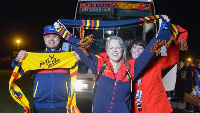 From left: John Lam, Linda Cox and Jacquie Radan, whose daughter Talia Radand plays for the Crows women's team, join two bus loads of Crows fans heading off to Melbourne, Thursday, September 28, 2017. The Adelaide Crows will play the Richmond Tigers in the Grand Final at the MCG this Saturday.