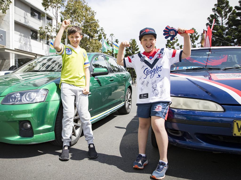 Raiders fan Stavris Mastoris from Canberra and Roosters fan Max Mulliett from Toongabbie ahead of the NRL Grand Final of Canberra Raider and Sydney Roosters tonight. Picture: Dylan Robinson