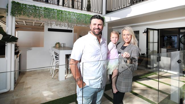 Toby and Donelan with daughter London, 2, at the New York-inspired villa they are selling at Palm Beach. Picture: Glenn Hampson