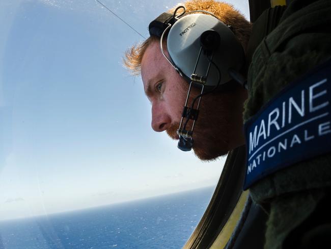 A French solider aboard an aircraft searches for debris from the crashed EgyptAir flight MS804. Picture: AFP/ MARINE NATIONALE/ Alexandre Groyer