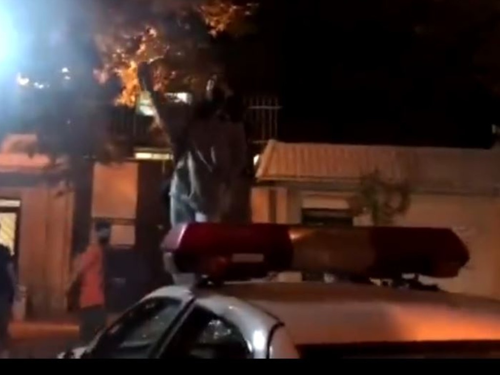 An activist stands on top of a police car during protests in Iran. Picture: Twitter