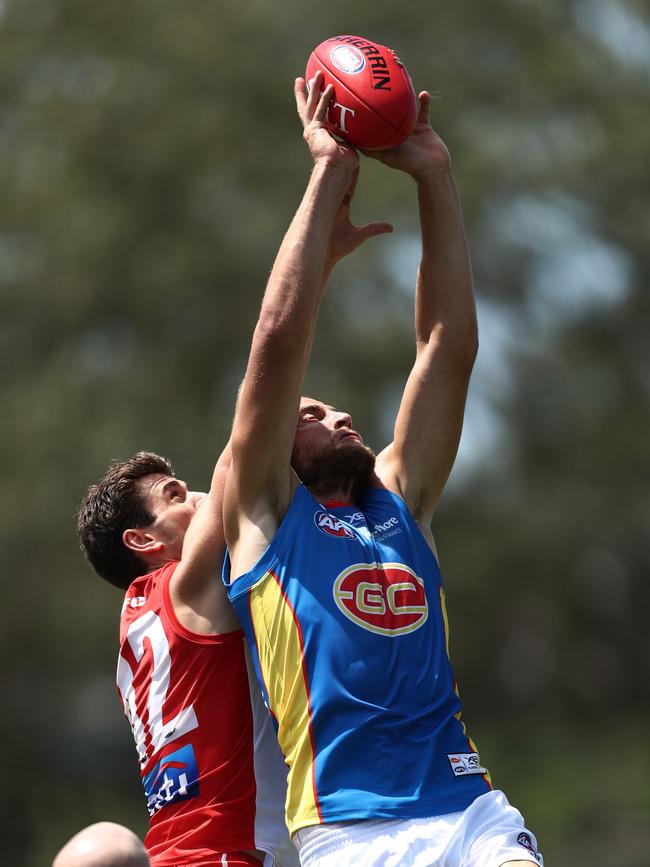 Gold Coast co-captain Jarrod Witts takes a strong mark against the Swans.