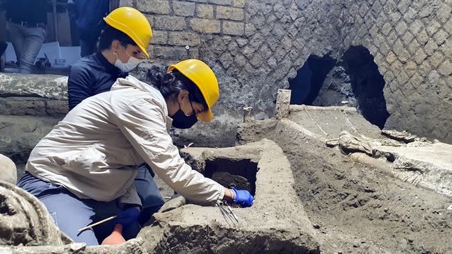 Archaeologists working in "The room of Slaves", an exceptionally well-preserved room for the slaves who worked in Villa Civita Giuliana in Pompeii. Picture: AFP