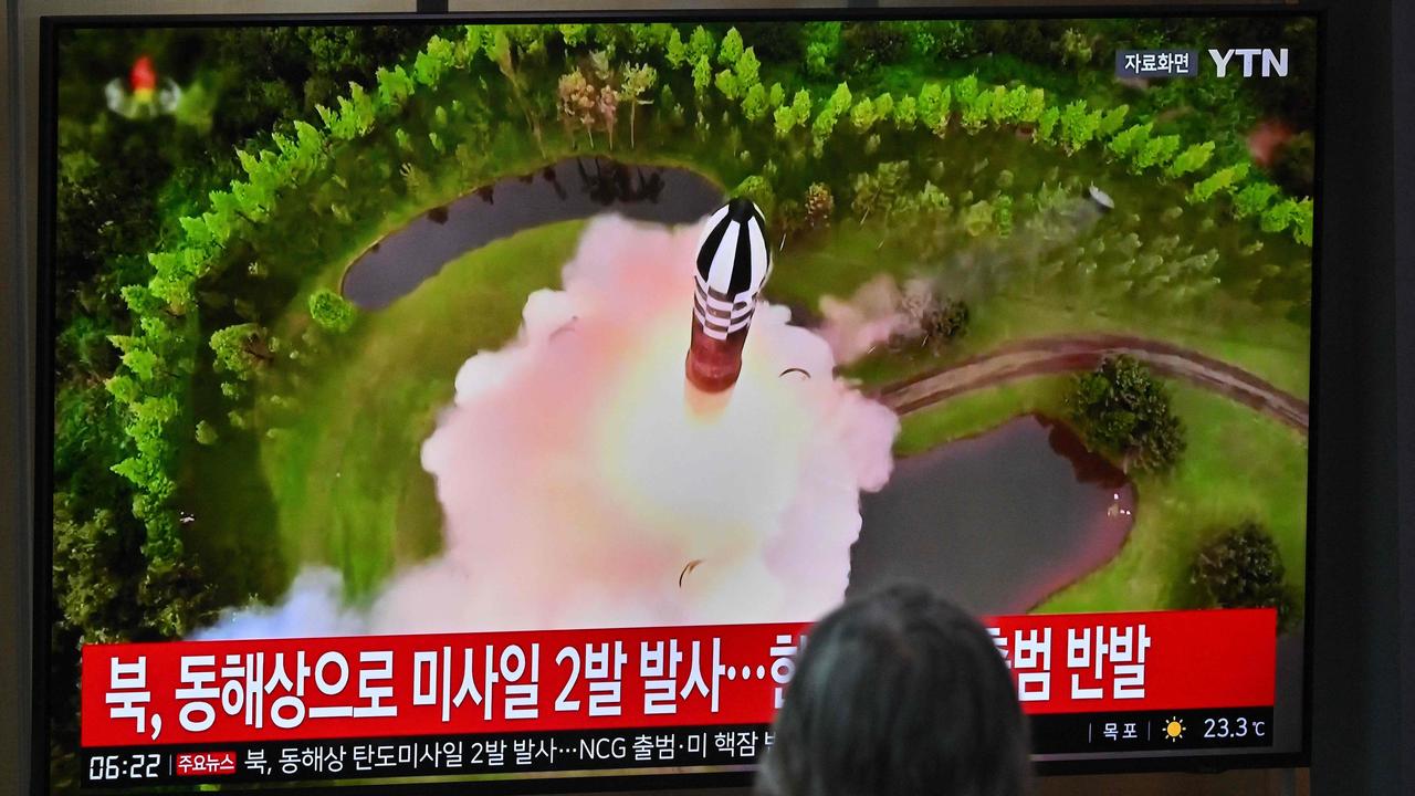 A man watches a television screen showing file footage of a North Korean missile test, at a railway station in Seoul. Picture: Jung Yeon-je/AFP