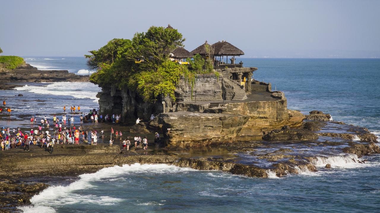 Tourists will now be banned from taking photos on rocky locations around the temple when waves are rough. Picture: Getty