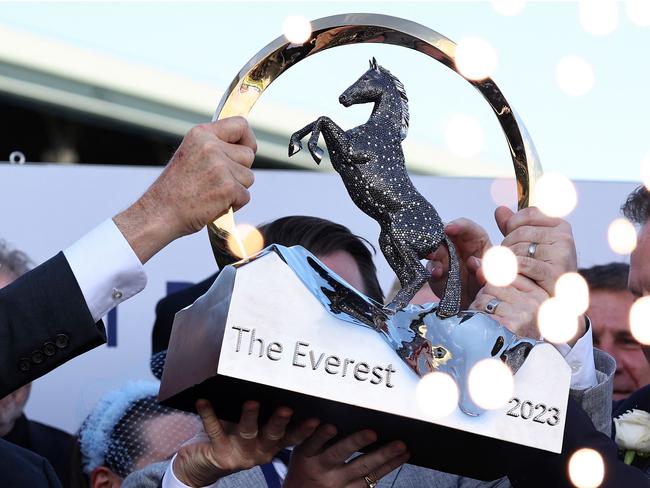 Team members of Australian sprinter, Think About It, lift the winning trophy after the world's richest turf race, The Everest, in Sydney on October 14, 2023. The Joe Pride-trained five-year-old stormed through the field in the final 100 metres at Royal Randwick to collect a whopping Aus$7.0 million (US$4.4 million) for barely a one-minute dash. (Photo by DAVID GRAY / AFP) / -- IMAGE RESTRICTED TO EDITORIAL USE - STRICTLY NO COMMERCIAL USE --