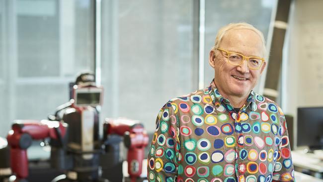 Prof Walsh standing in front of UNSW's Baxter Robot. Picture: Grant Turner/UNSW/Supplied